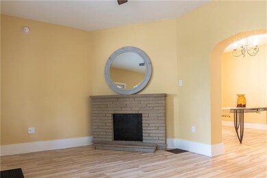 Step into the living room with corner fireplace, c