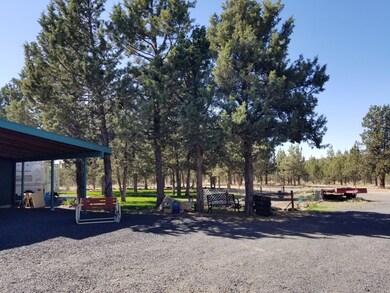 Backyard carport to left