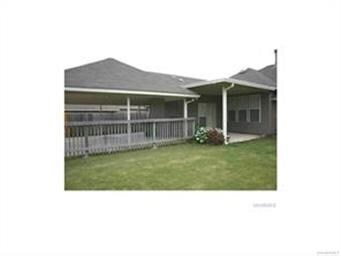 Backyard/side yard viewing of covered patio and ca