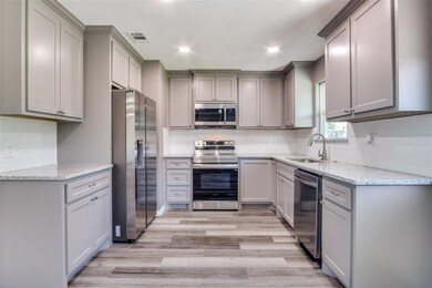 Kitchen with stainless steel appliances, light sto