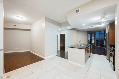 Kitchen with an island with sink, light tile patte
