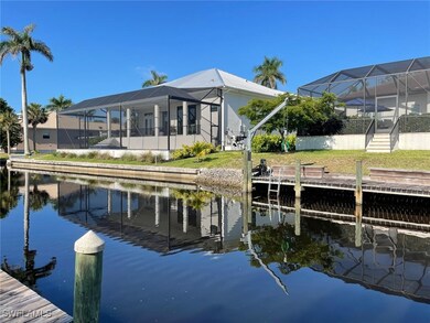 Dock area featuring a water view, glass enclosure,