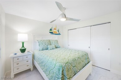 Bedroom with light marble finish floors, a closet, and ceiling fan