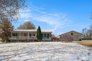 Single story home with an outdoor structure and covered porch