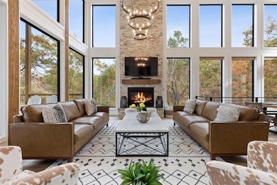 Family room with 20' stone fireplace and cedar bea