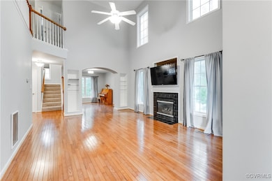 Unfurnished living room with arched walkways, ceil