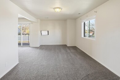 Empty room featuring carpet floors and baseboards