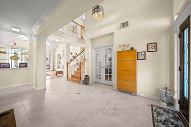 Welcoming foyer offers tile flooring, high ceilings - enjoy the light and bright feel of this welcoming space!