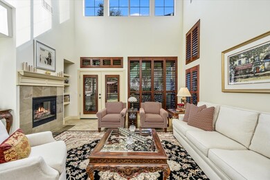 Tiled living area with a towering ceiling and a f