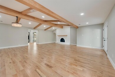 Living room featuring vaulted ceiling with beams, 