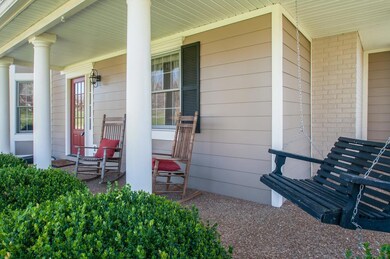 Rock away your day from this beautiful covered porch