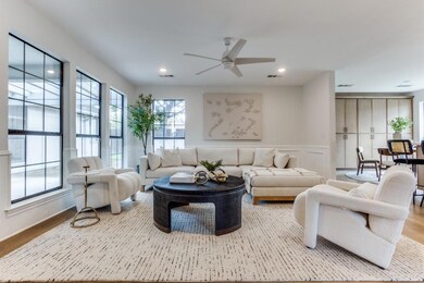 Living room featuring ceiling fan and light hardwo