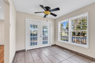 Interior space with ceiling fan, light tile patter