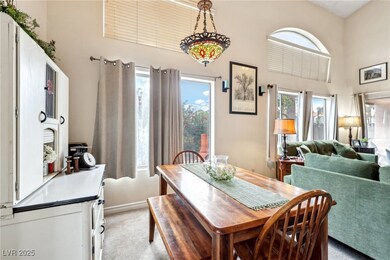 Dining space with light colored carpet, a high cei