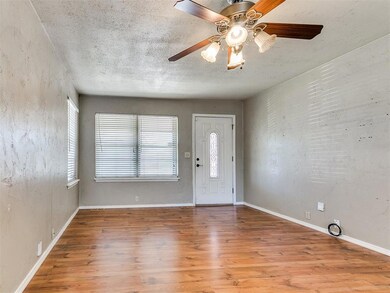 Entryway with baseboards, a ceiling fan, wood fini