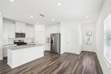 Kitchen with stainless steel appliances, sink, whi
