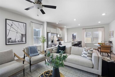 Living area featuring baseboards, light wood finis