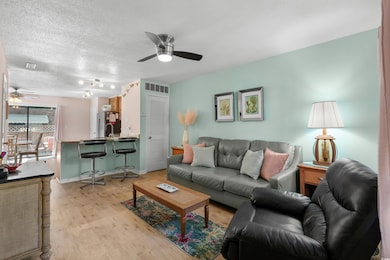 Living room featuring visible vents, baseboards, c