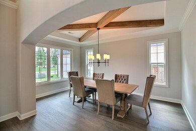 Dining room featuring beamed ceiling, crown moldin