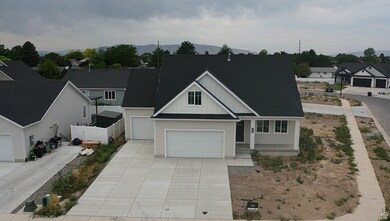 View of front facade with board and batten siding, roof with shingles, and driveway