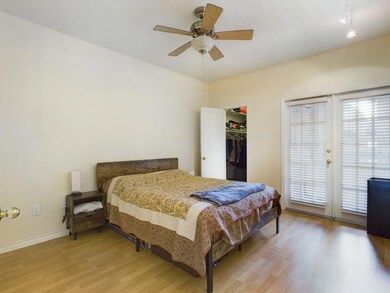 Bedroom featuring a walk in closet, multiple wind