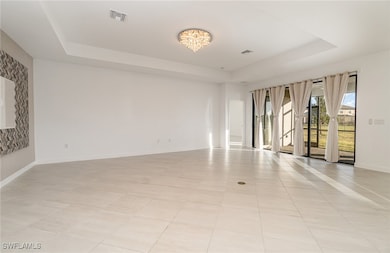 Spare room featuring a notable chandelier, a raise