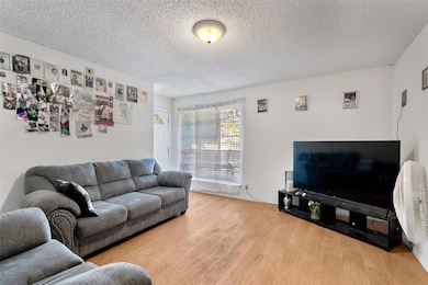 A look at the front entryway and large window that brings  a warm glow to the space.