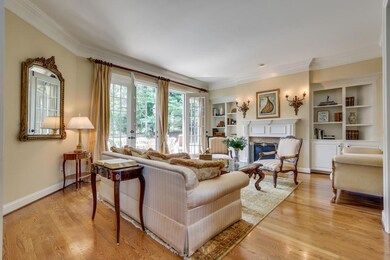Formal Living Room -  •Double French Doors lead to Patio/Pool Area for Indoor/Outdoor Entertaining•Gas Fireplace•Built-In Cabinetry & Shelving•Hardwood Flooring•Gorgeous Crown Molding•