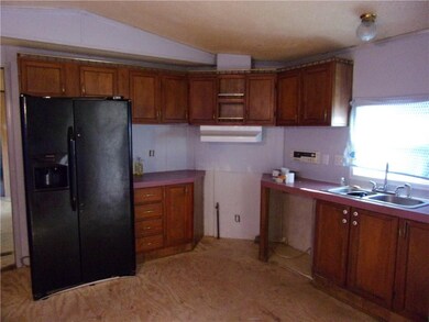 Refrigerator with icemaker, new vented hood, stainless steel sink.