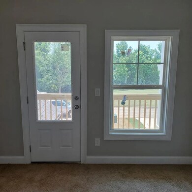 Doorway to outside with carpet, baseboards, and plenty of natural light