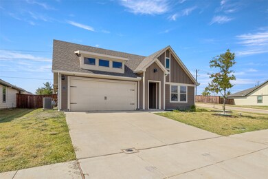 View of front of house with a shingled roof, concrete driveway, a garage, and board and batten siding