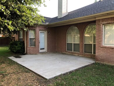 Rear view of property with a patio area, a chimney