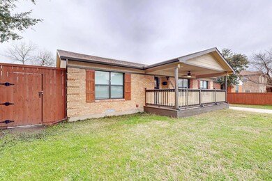 Rear view of house with a yard and ceiling fan
