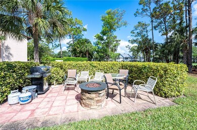 View of patio featuring an outdoor fire pit and gr