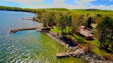 Drone / aerial view of a large body of water and a heavily wooded area