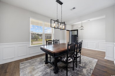 Dining room with an inviting chandelier and dark h