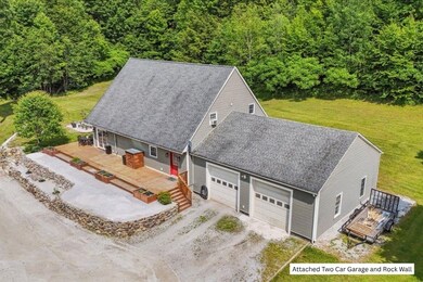 Attached Two Car Garage and Rock Wall