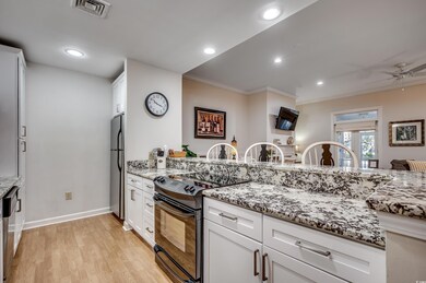Kitchen with electric range, stainless steel fridg