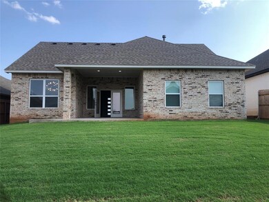 Rear view of house with a lawn
