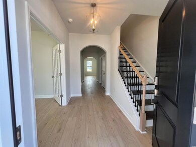 Foyer entrance featuring a chandelier and light wood-type flooring