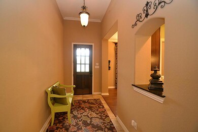 Entry offering a beveled glass front door, tile floors and crown molding.