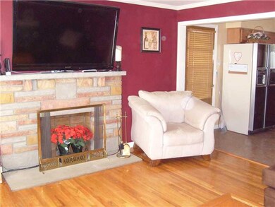 Living Room. Decorative fireplace and refinished floors.