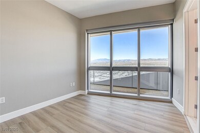 Unfurnished room featuring baseboards, a mountain