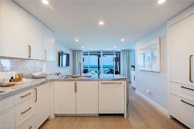 Kitchen featuring tasteful backsplash, white cabinetry, a peninsula, light wood-style flooring, and recessed lighting