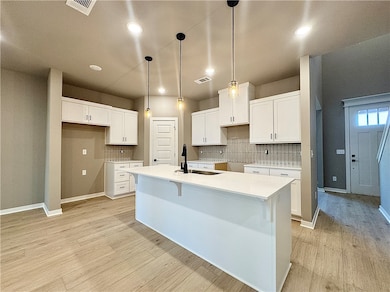 The quartz countertops, walk-in pantry, and stainl