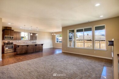 Great room with gas fireplace and large windows. This is a general representation of floor plan and may vary from actual home constructed. Features in photos, upgrades, elevation, materials, dimensions and layout all subject to change.