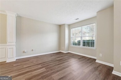 Spare room with decorative columns, visible vents,