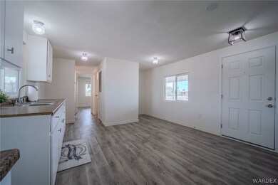 Kitchen with white cabinets, sink, and hardwood /