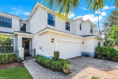 Mediterranean / spanish house with a garage, stucco siding, decorative driveway, and a tile roof