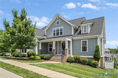 View of front of home with a shingled roof, board and batten siding, a porch, a front lawn, and brick siding